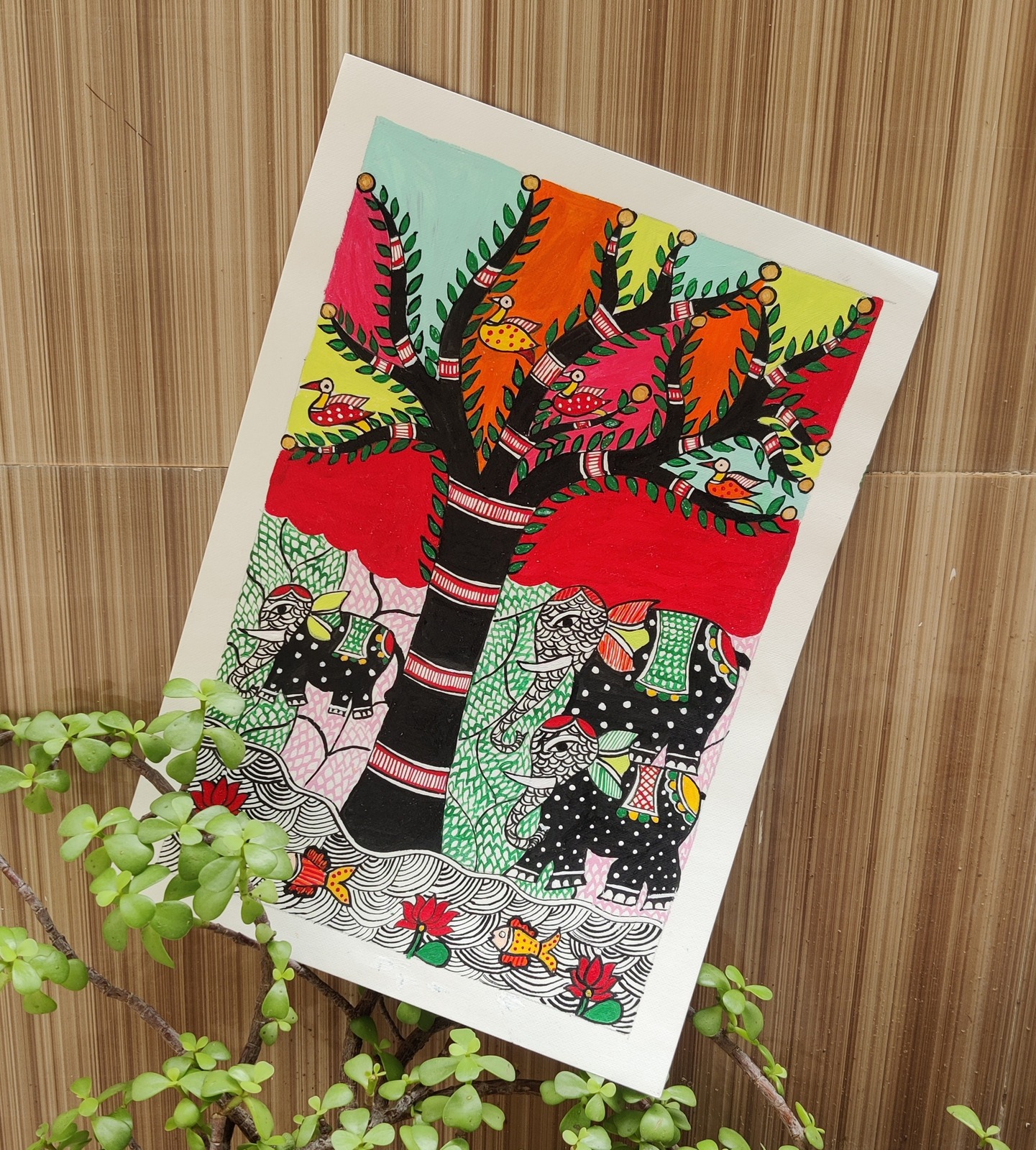 Tree with seated figures, fish and birds beneath -- a folk-narrative composition.